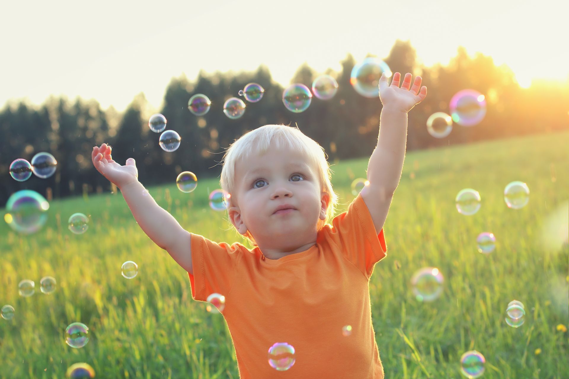 child playing with bubbles