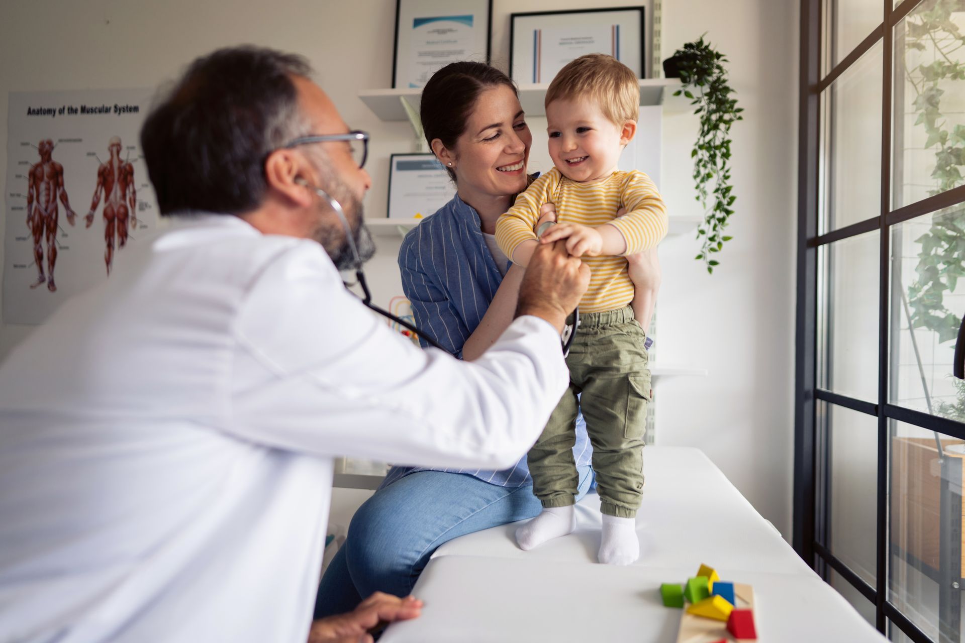 Baby getting examined by doctor