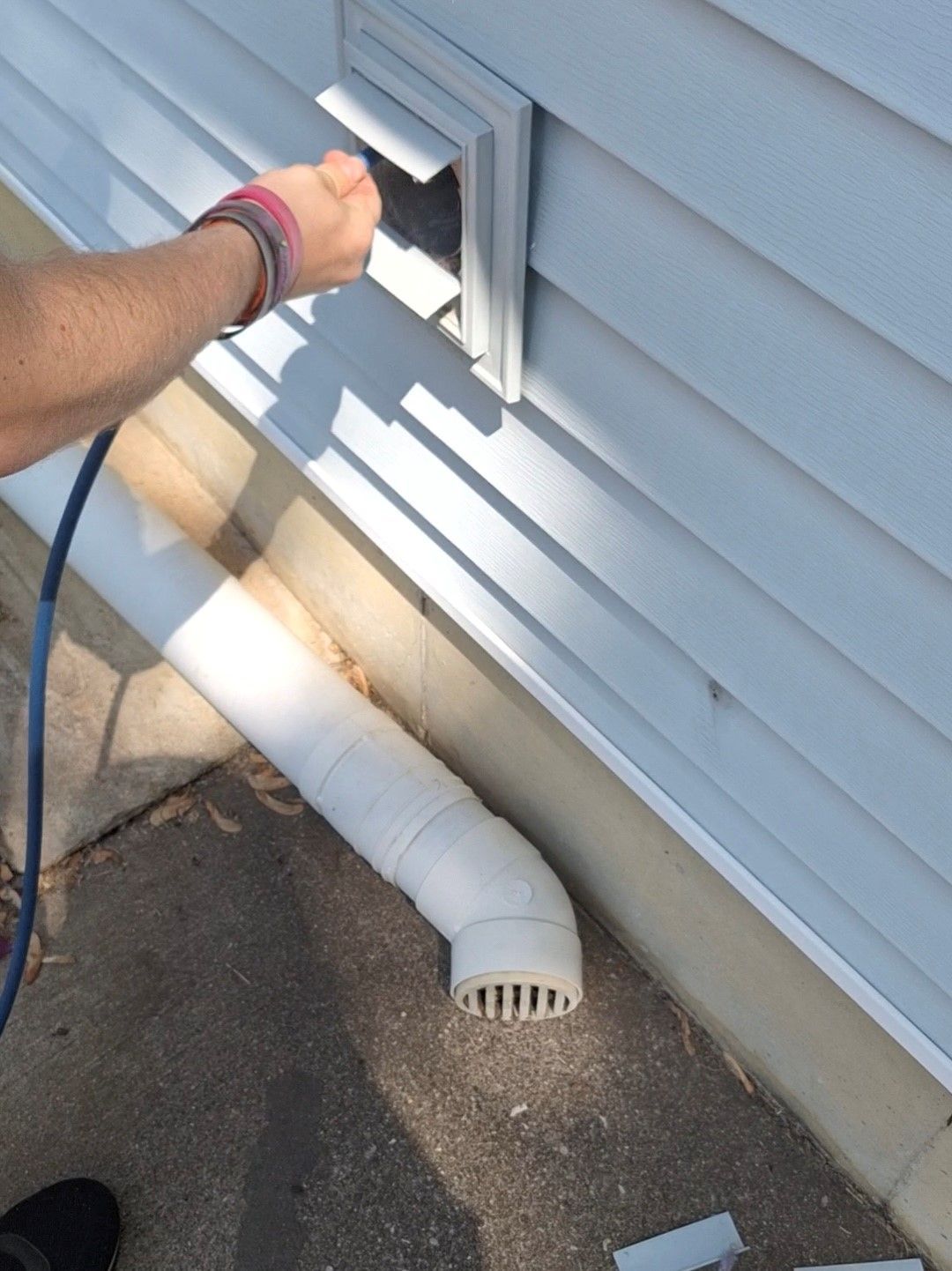 Looking down a metal duct in a room with a wooden ceiling.