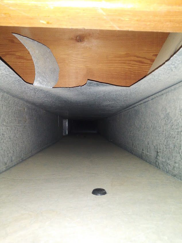A very long duct with a hole in the middle of it.