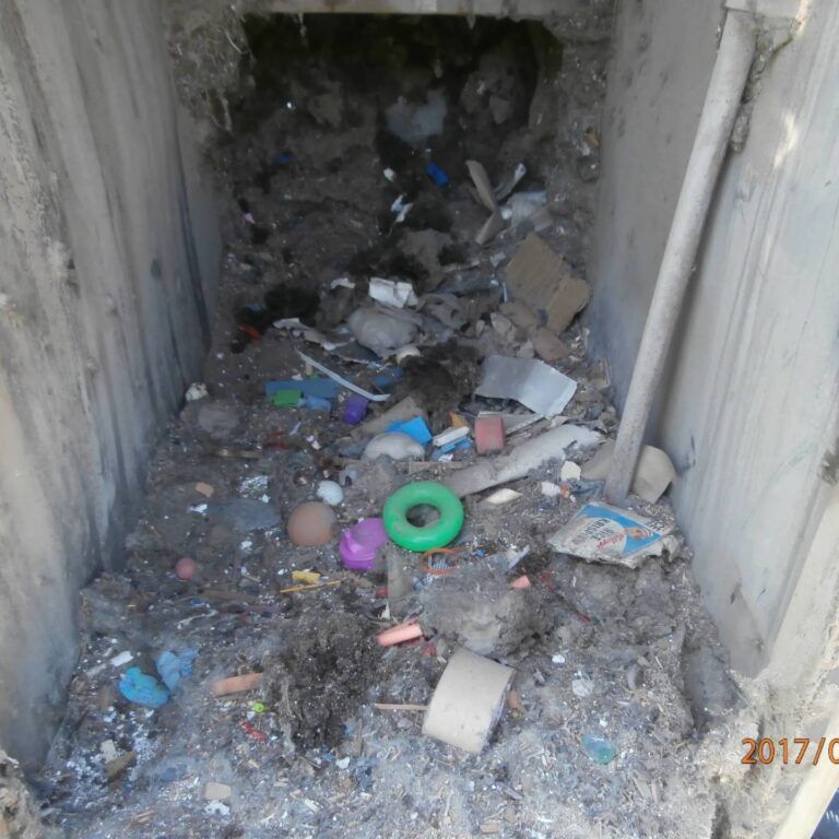 A pile of garbage with a green ring in the middle.