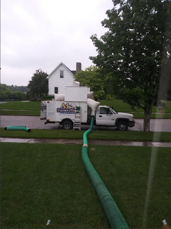Looking down a very long duct with a hole in the ceiling.