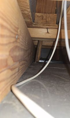 A bunch of wires are hanging from the ceiling of a room.