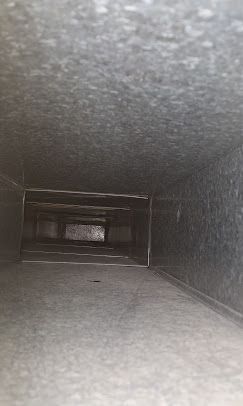 Looking down a metal duct in a building.