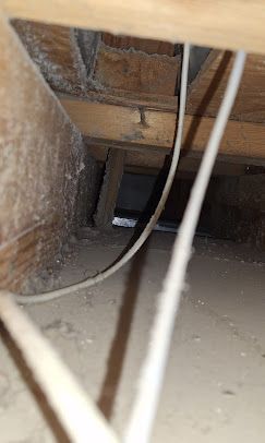 Wires are hanging from the ceiling of a room.