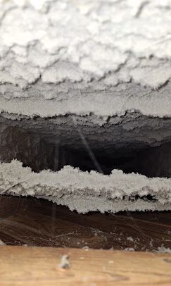 A close up of a ceiling with a hole in it.