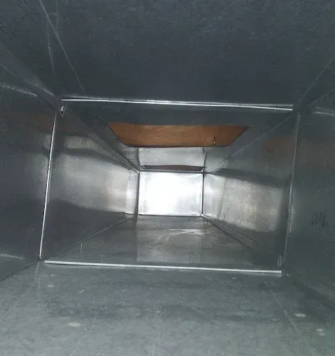 A close up of a wooden ceiling with a hole in it.