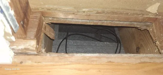 A wooden ceiling with a hole in it.