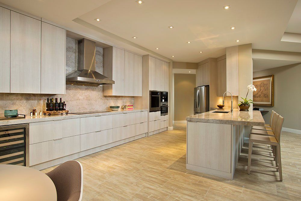 A large kitchen with white cabinets and stainless steel appliances.