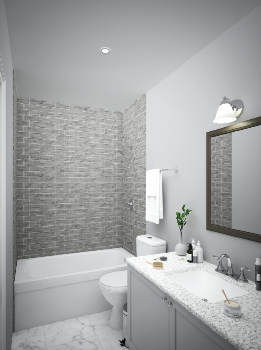 A bathroom with a sink , toilet , bathtub and mirror — Naples, FL — Genuine Home Builders, Inc.