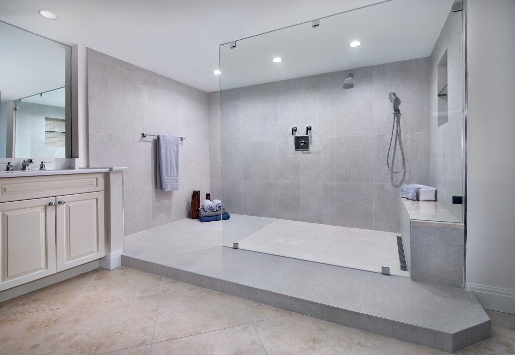 A bathroom with a walk in shower and a sink.