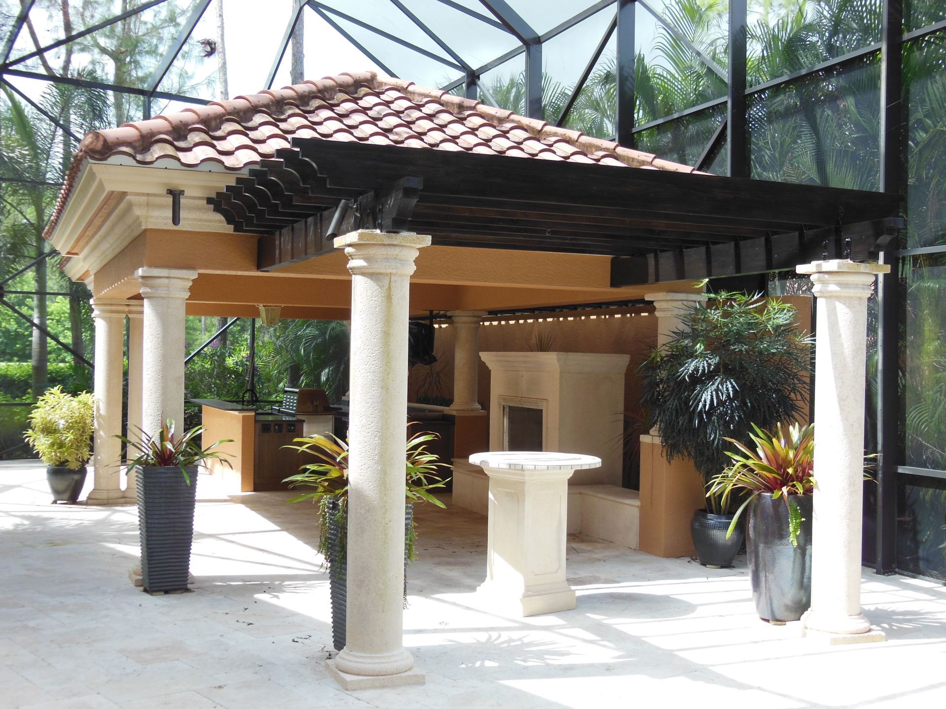 A gazebo with columns and a tiled roof.