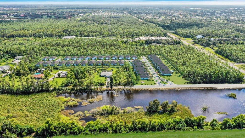 An aerial view of a residential area surrounded by trees and a lake — Naples, FL — Genuine Home Builders, Inc.