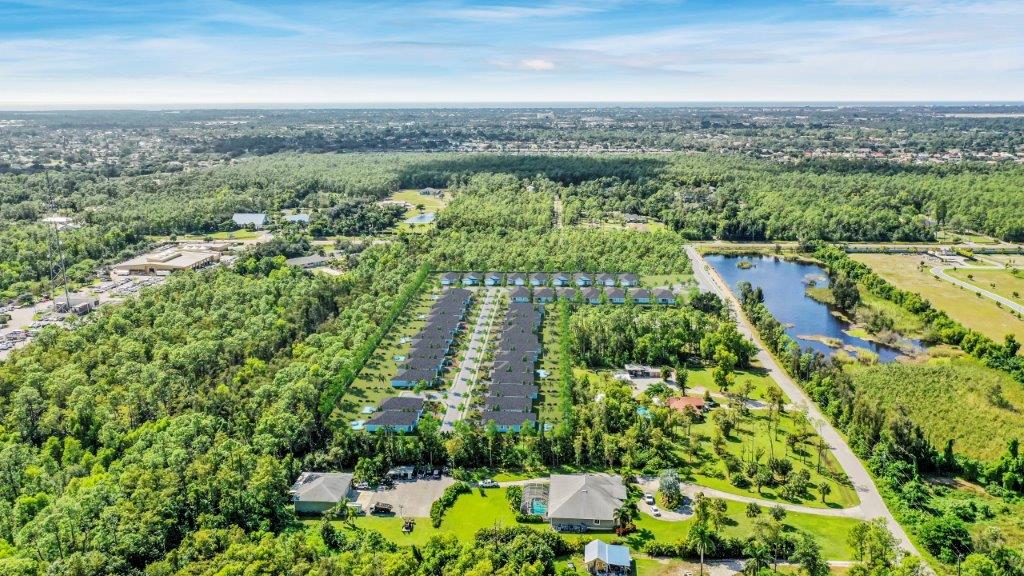 An aerial view of a residential area surrounded by trees and a lake — Naples, FL — Genuine Home Builders, Inc.