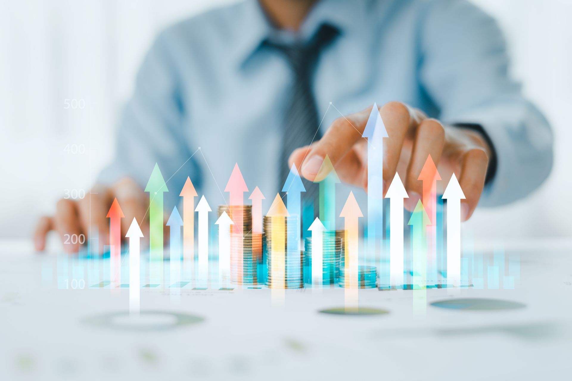 A Man Is Pointing at a Graph With Arrows Pointing Up — Kansas City, MO — SD Smith Business Resource Consulting Firm