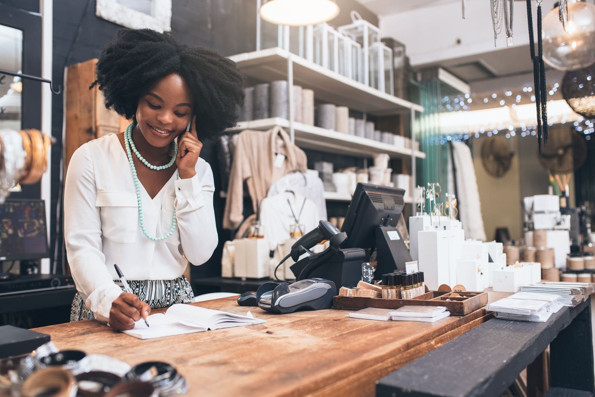 A Woman Is Sitting at a Counter in a Store — Kansas City, MO — SD Smith Business Resource Consulting Firm