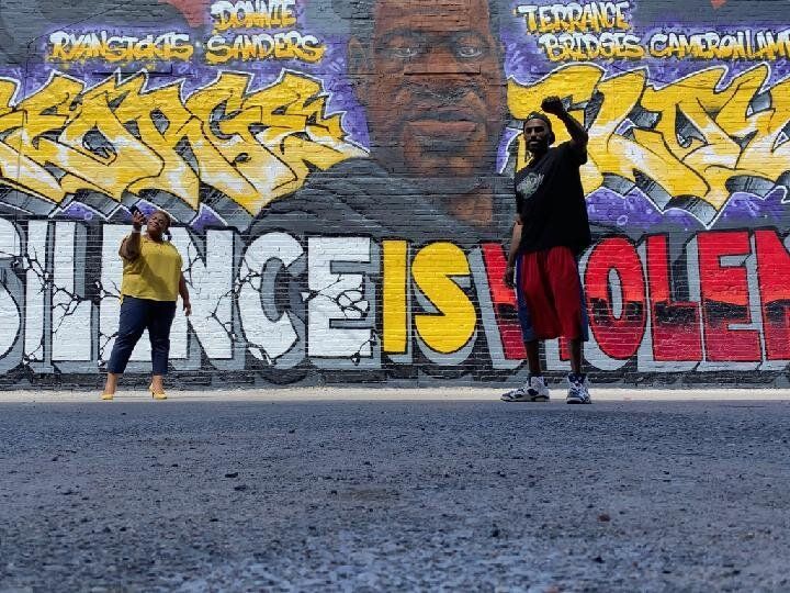 A Couple of People Standing in Front of a Graffiti Wall — Kansas City, MO — SD Smith Business Resource Consulting Firm