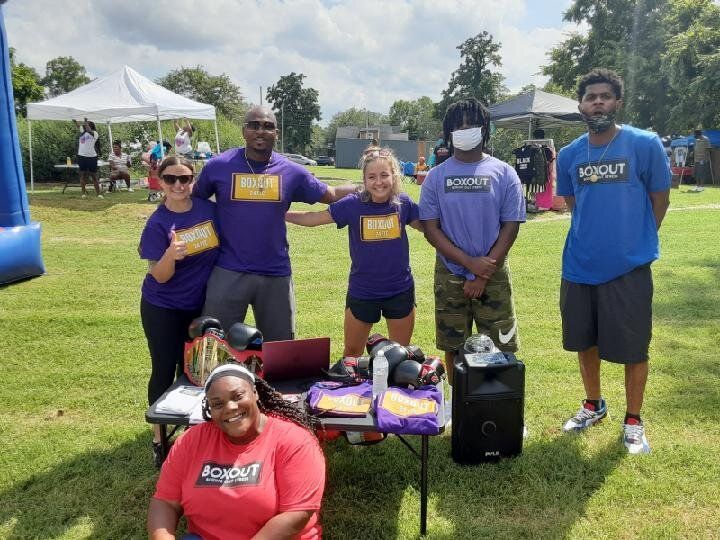 A Group of People Are Posing for a Picture in a Field — Kansas City, MO — SD Smith Business Resource Consulting Firm