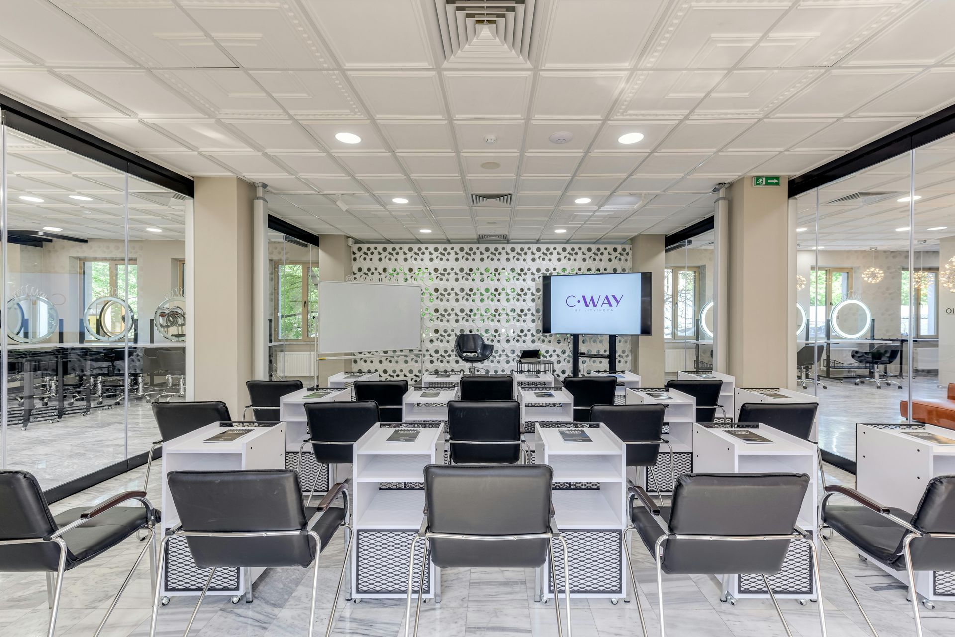 Microphone in a recording studio, close-up. Silver mic in a black frame. Blurred background with studio equipment.