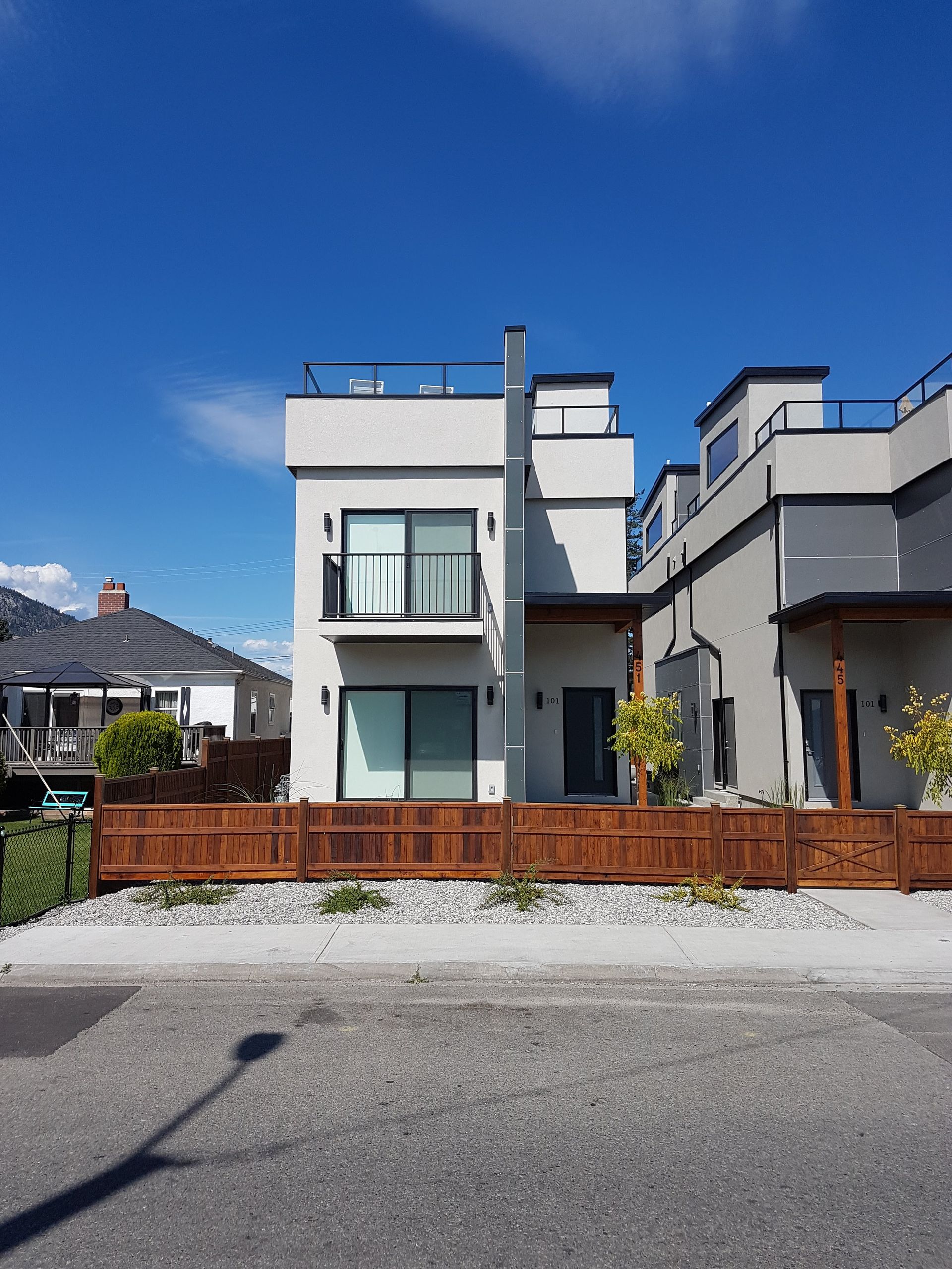 A large white house with a wooden fence in front of it