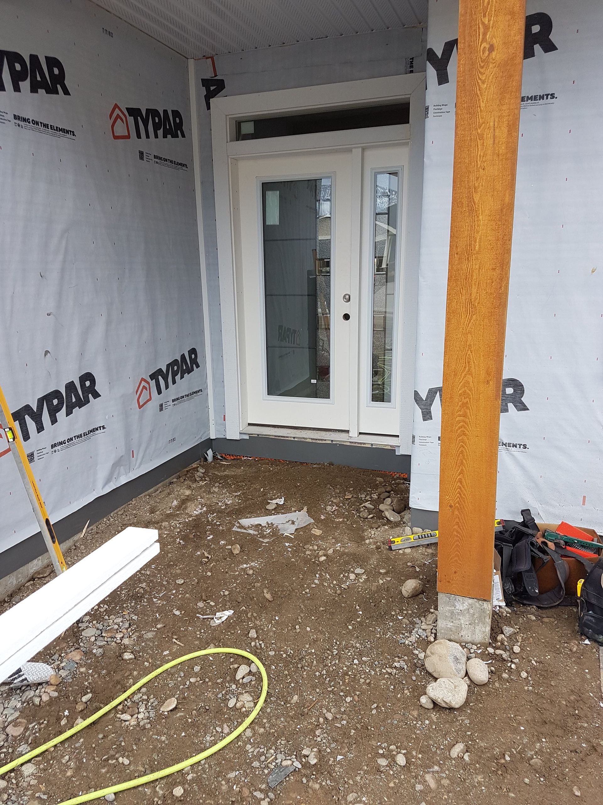 A door is being installed on the side of a building.