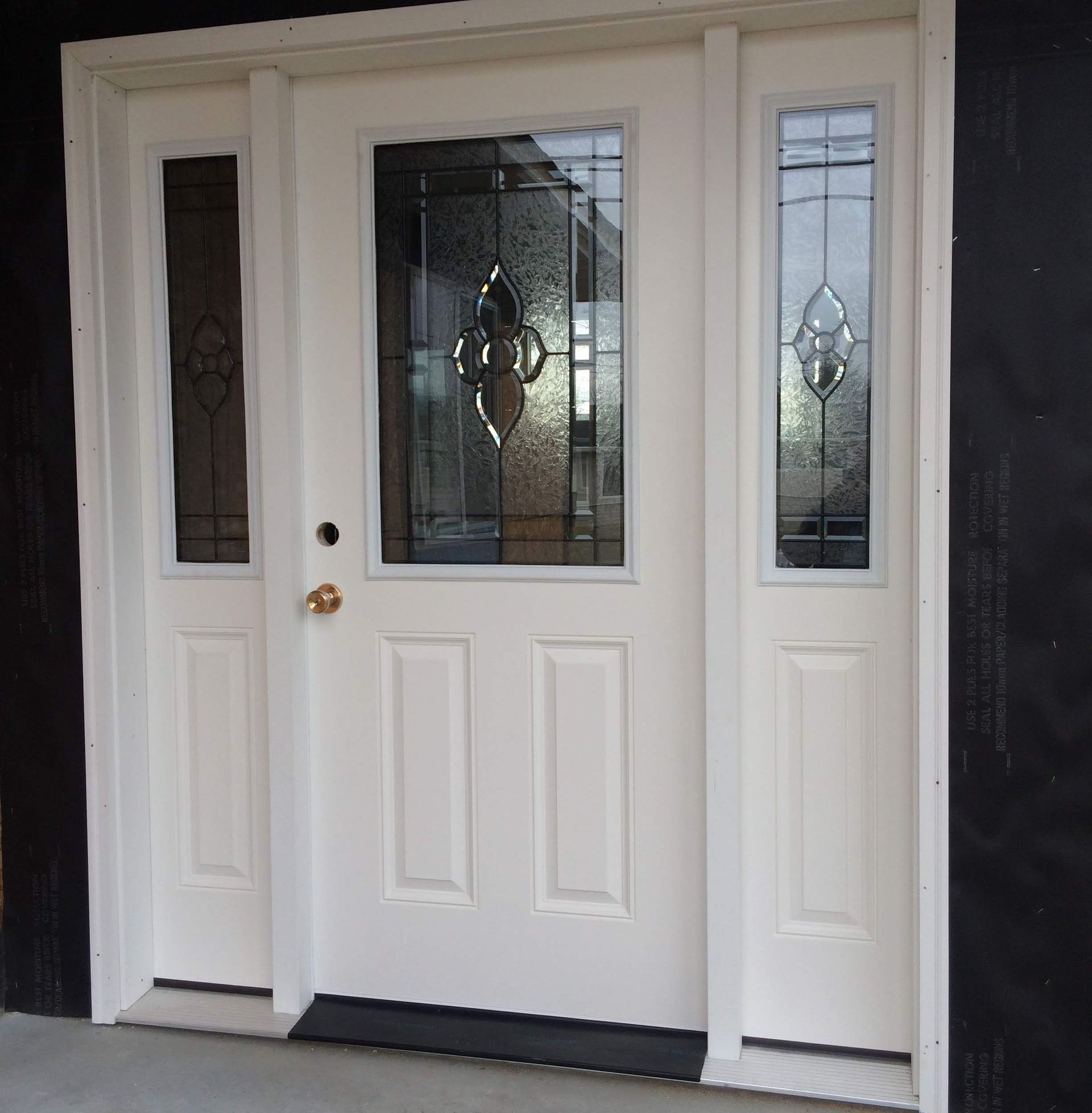White entry door with glass panels and sidelights.