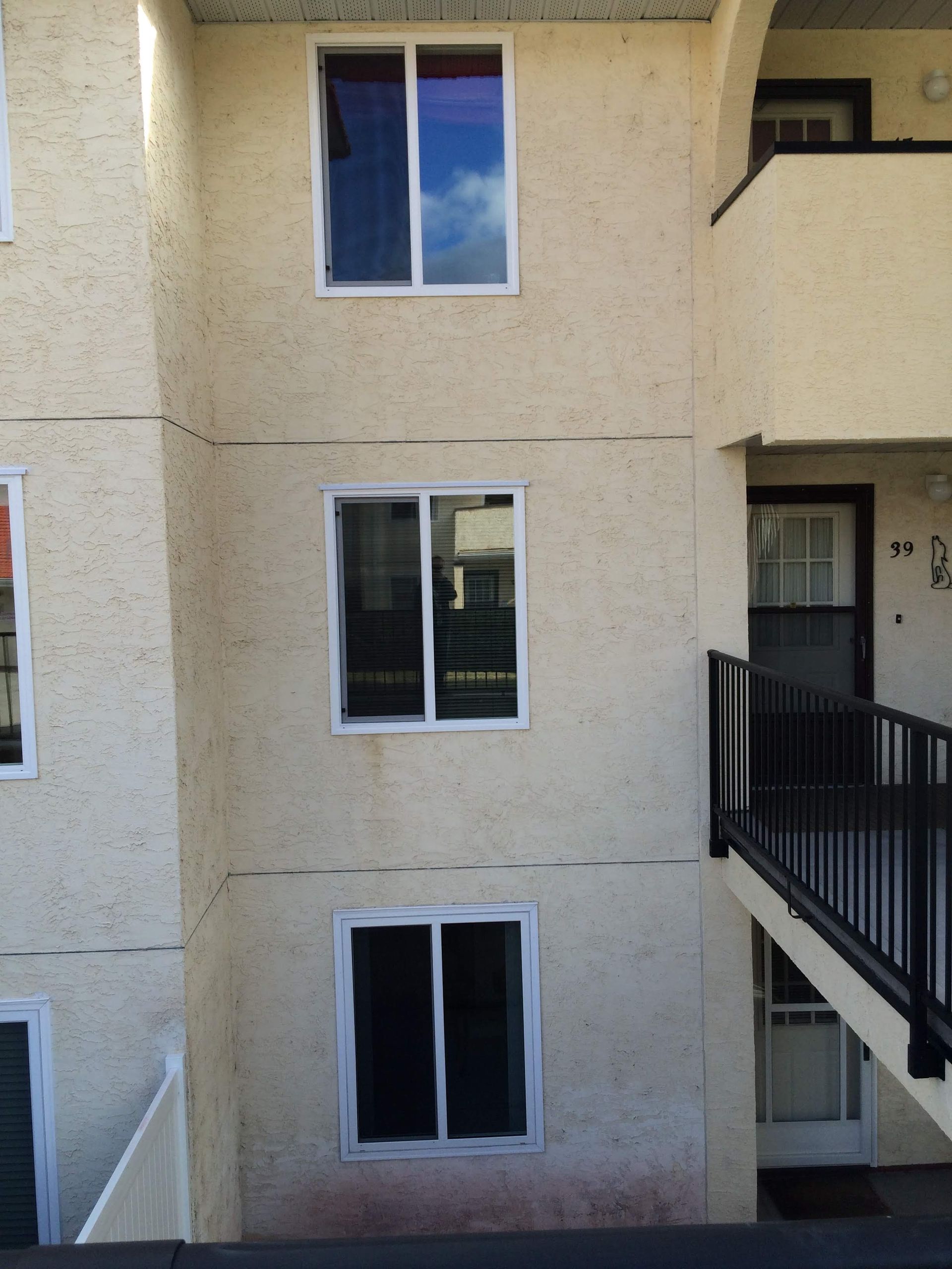 A building with a balcony and stairs leading up to it