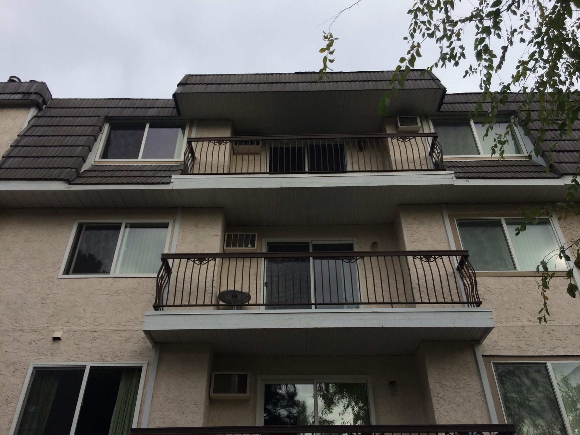 A building with a balcony on the top of it