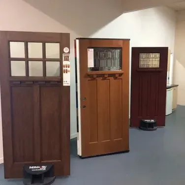 Three different types of doors are lined up in a room