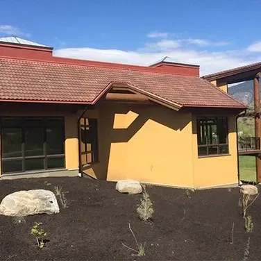 A yellow house with a red tile roof