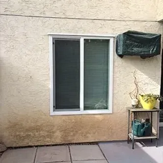 There is a window on the side of a building.