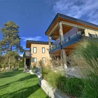 A large house with a large lawn in front of it.