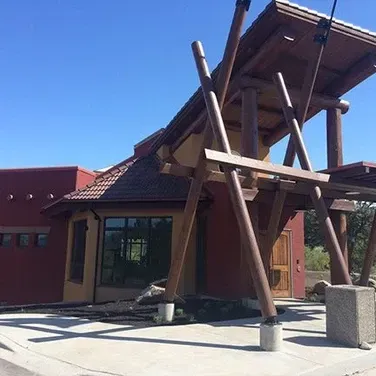 A red building with a wooden structure in front of it