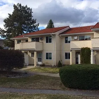 A house with a red roof and a lot of windows
