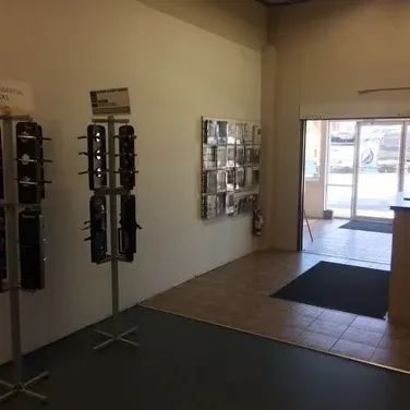 A room with a display of keys on a stand in a store.