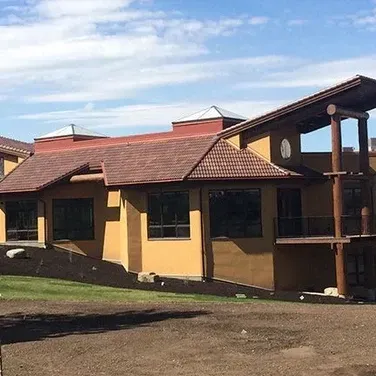A large yellow building with a red roof