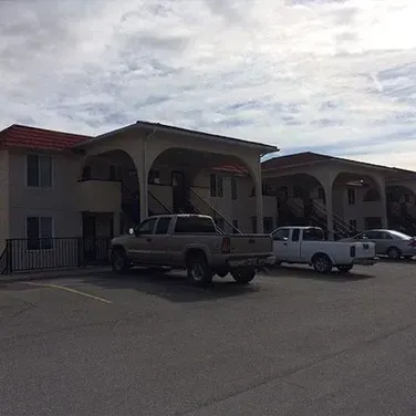 A couple of trucks are parked in front of a building.