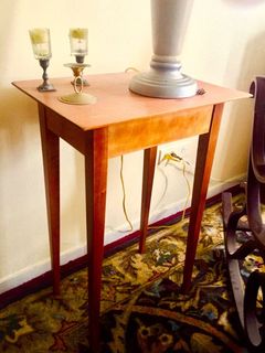 A small table with two candles on top of it