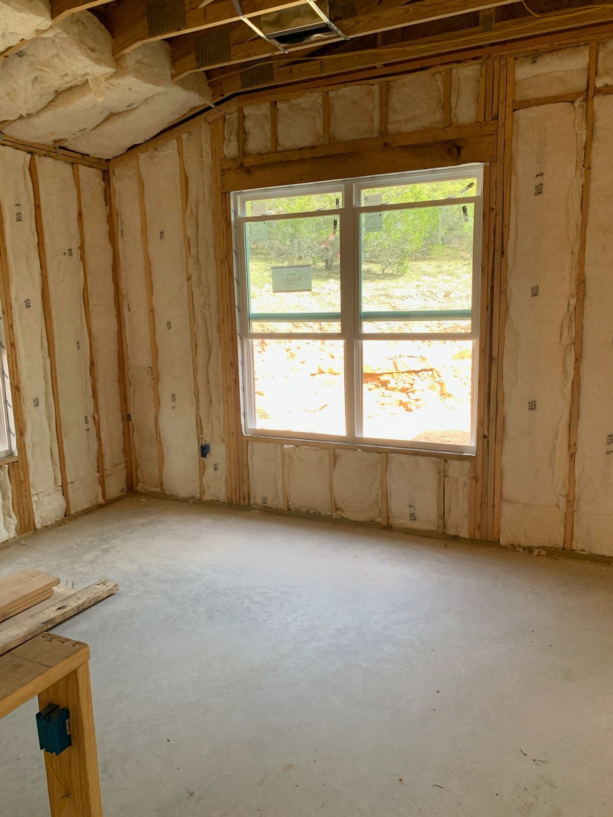 A room with a lot of insulation on the walls and a window.