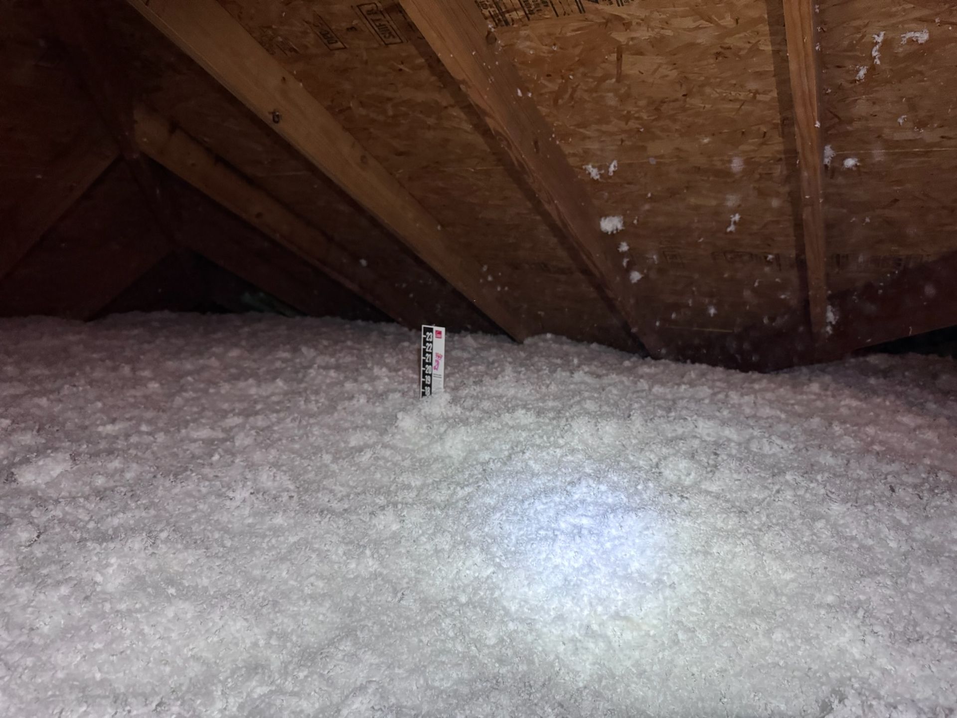 There is a lot of insulation in the attic of a house.