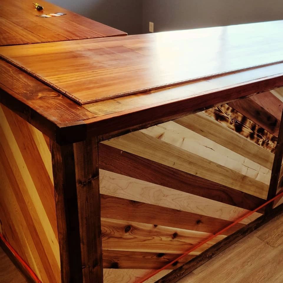 Wooden bar with angled planks in various wood tones and a finished countertop
