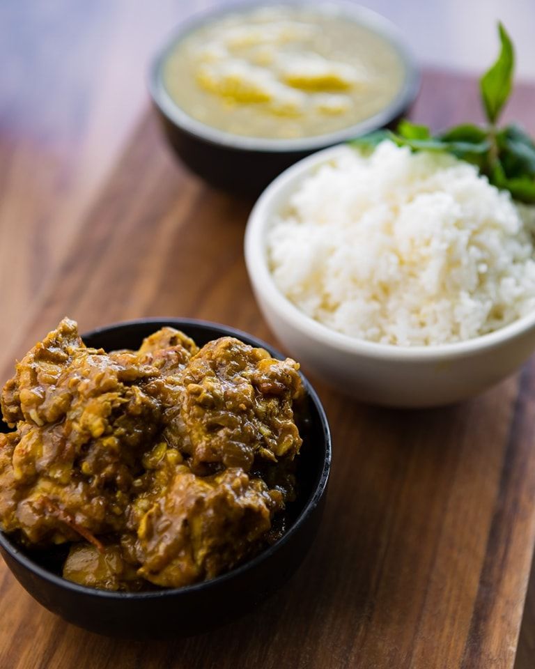 A Bowl of Rice and a Bowl of Curry on a Wooden Table — Monty Brewing Co. In Highfields, QLD