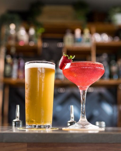 A Glass of Beer and a Glass of Strawberry Martini on a Bar — Monty Brewing Co. In Highfields, QLD