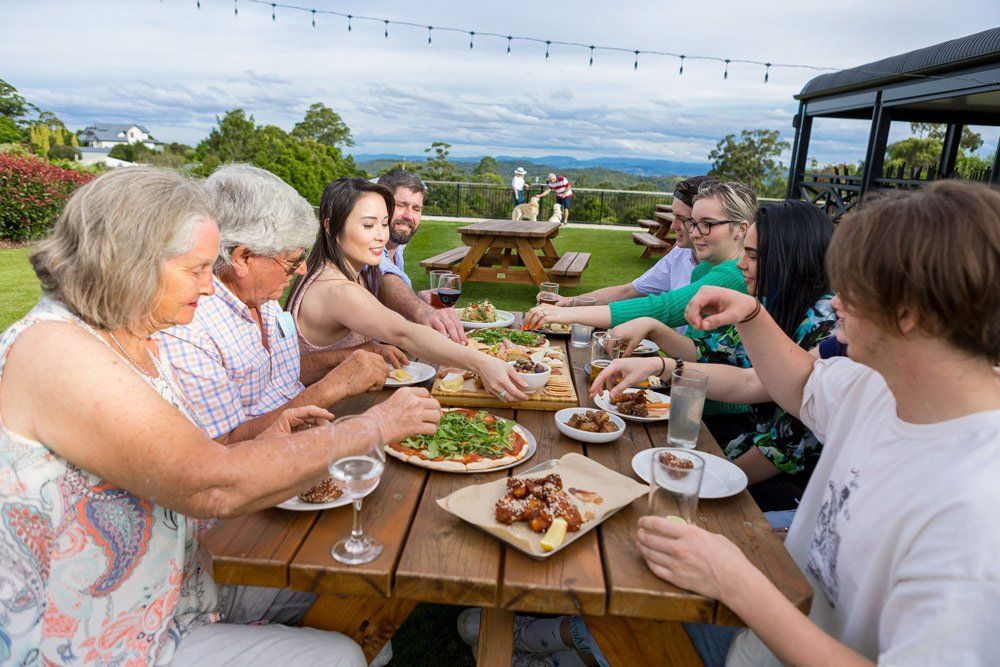 Happy Family Eating at the Restaurant — Monty Brewing Co. In Highfields, QLD