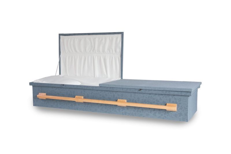 a blue coffin with the lid open on a white background .