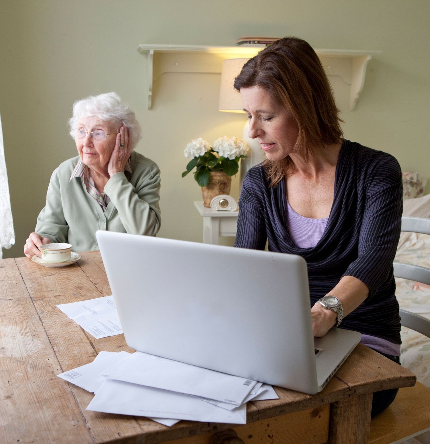 Woman Using Laptop With Elder Woman — Princeton, IN — Friends and Family Caregivers