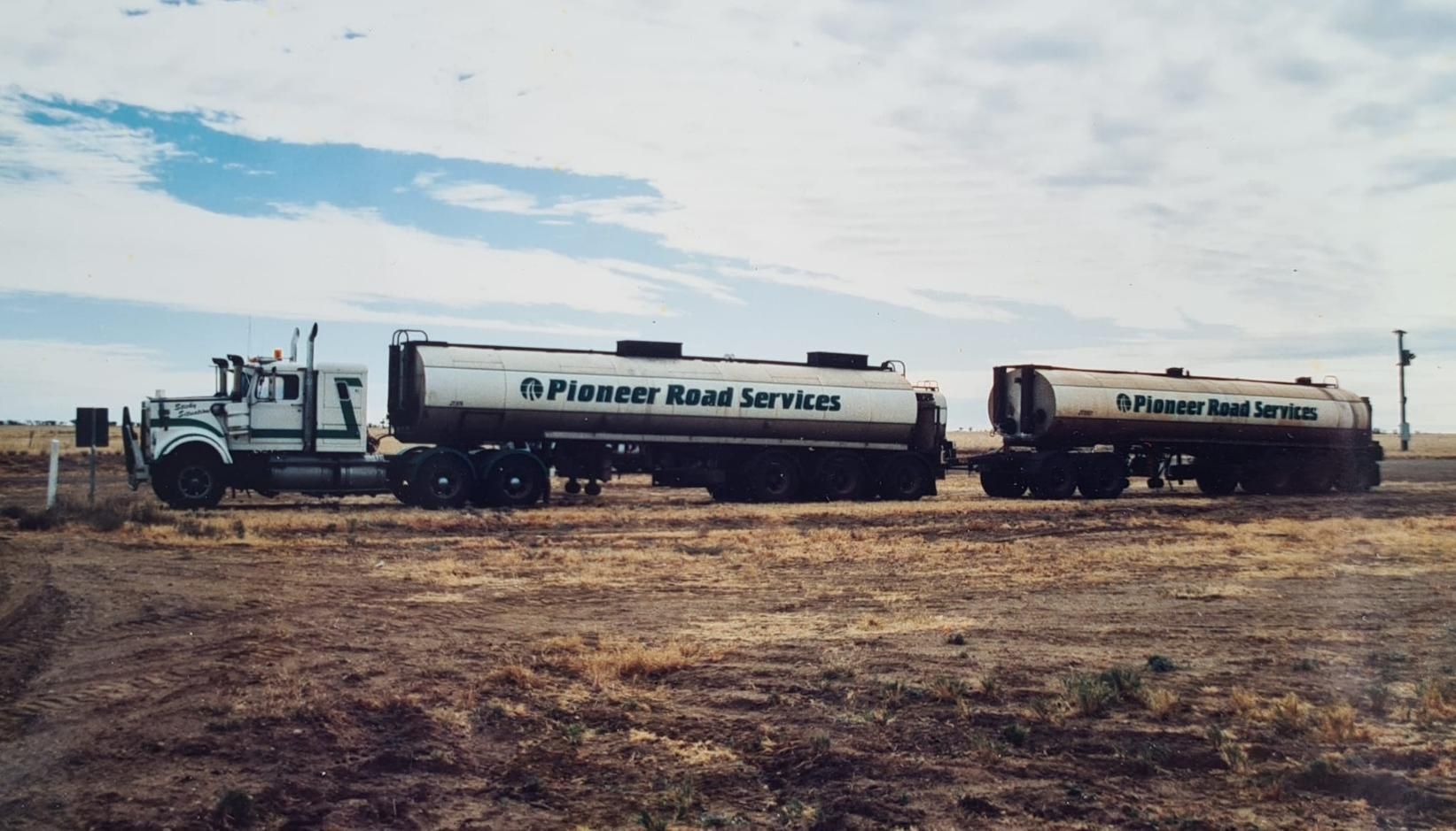 Two Tanker Trucks From Firestar Road Services Are Parked In A Field — Willow's Bitumen Haulage Pty Ltd In Northern Territory
