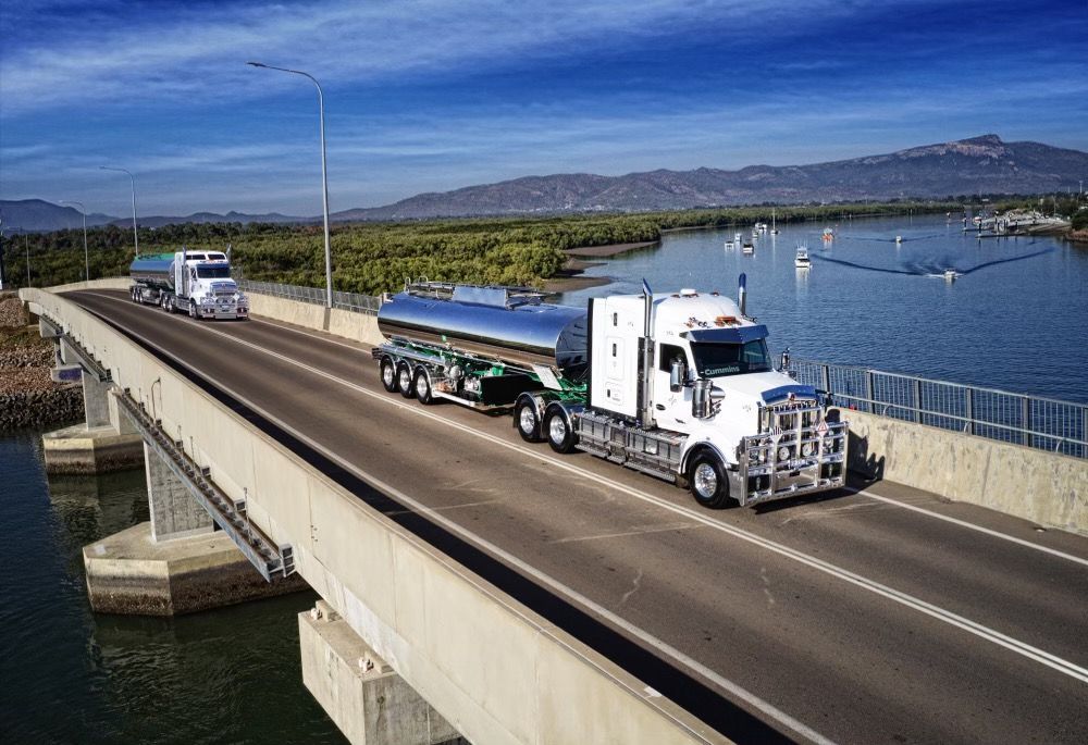 Two Trucks Driving On A Bridge — Willow's Bitumen Haulage Pty Ltd In New South Wales