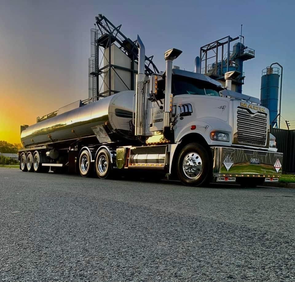 A Semi Truck Is Parked On A Road At Sunset — Willow's Bitumen Haulage Pty Ltd In Stuart, QLD