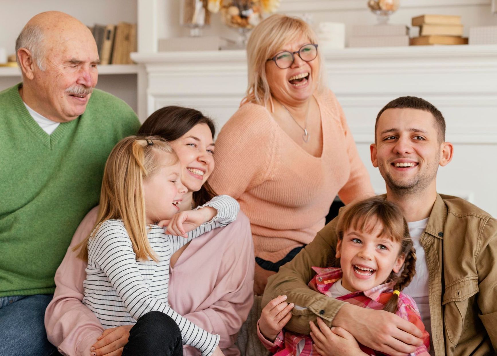 A family is posing for a picture together in a living room.
